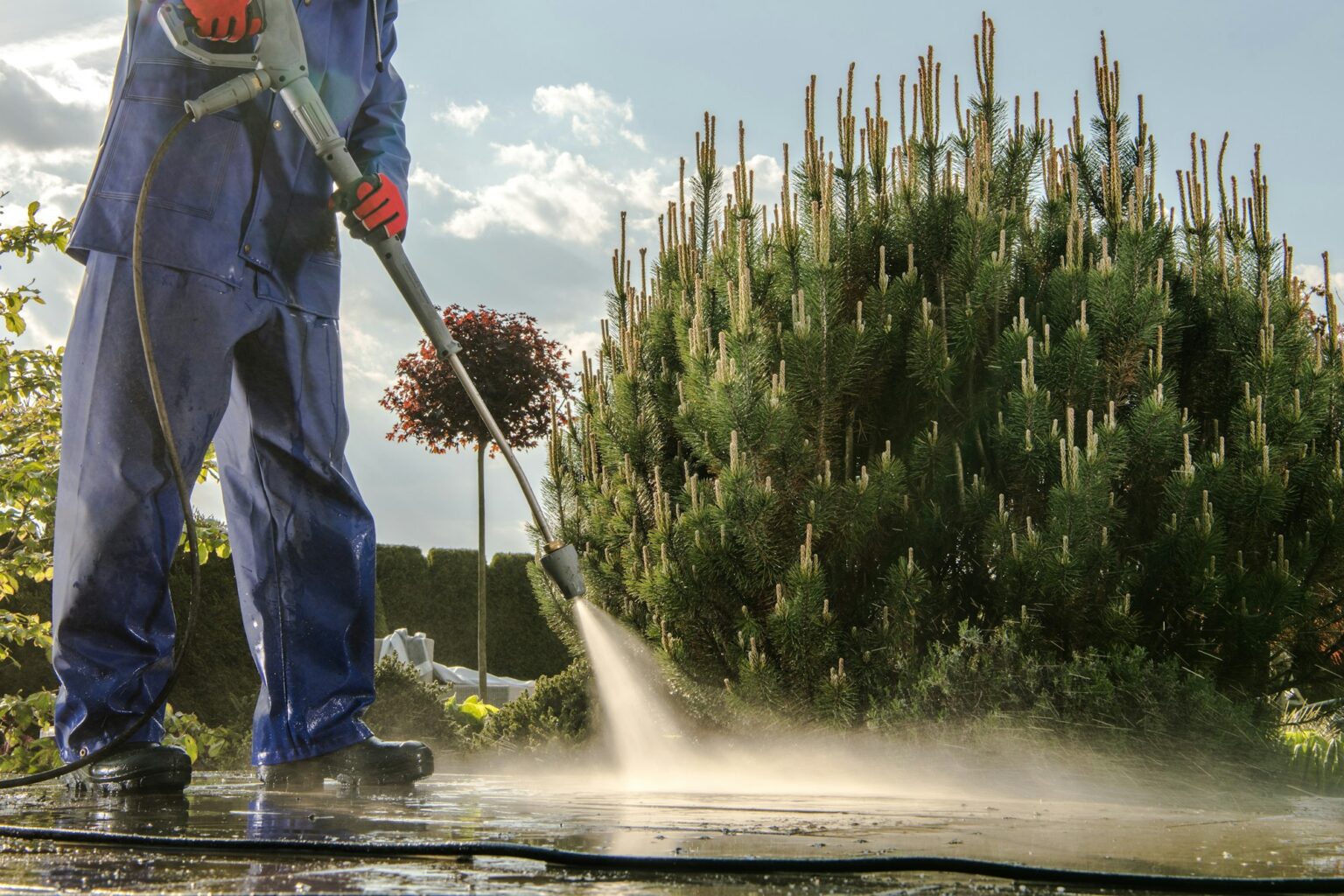 Gardener Washing Garden Paths